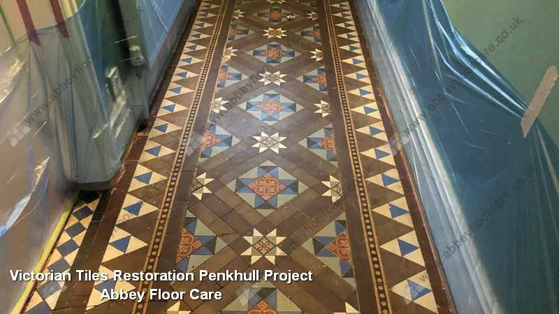 Original patterned Victorian hallway tiles in Penkhull showing embedded residue and muted colour
